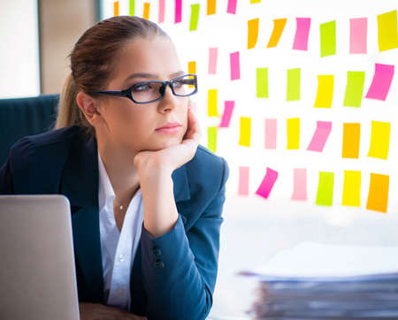 Beautiful female employee with many conflicting prioritiesの写真素材