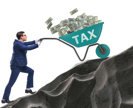 Businessman pushing tax wheelbarrow uphillの写真素材