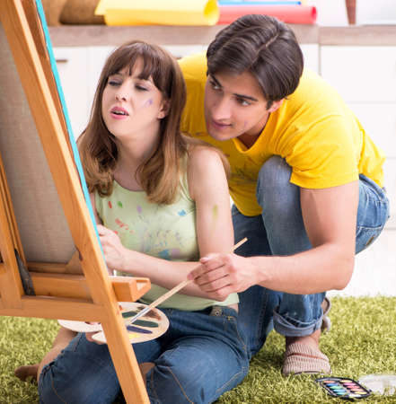 Young couple enjoying painting at homeの写真素材