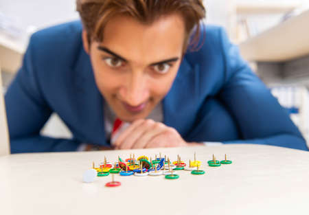Office prank with sharp thumbtacks on chair