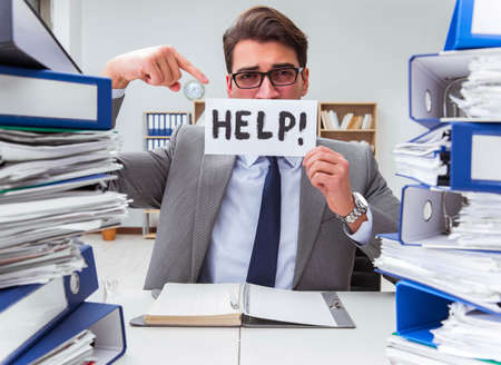 Busy businessman asking for help with workの写真素材