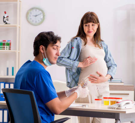 Pregnant woman visiting doctor for check-upの写真素材