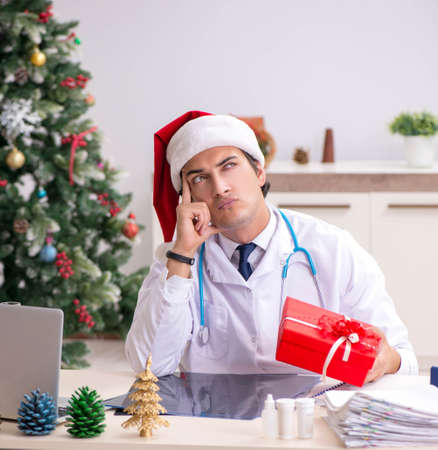 Doctor with gift box in the hospitalの写真素材