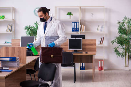 Young male employee in self-isolation conceptの写真素材