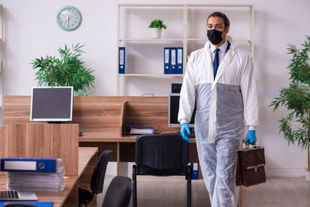 Young male employee in self-isolation conceptの写真素材