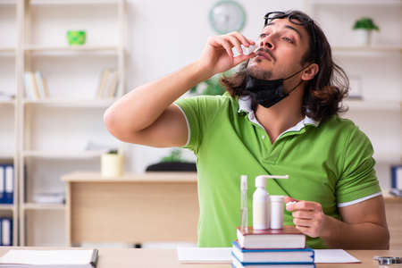 Young man student studying at home in self-isolation conceptの写真素材