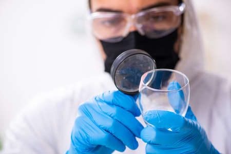 Male expert criminologist working in the lab for evidenceの写真素材