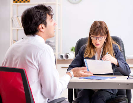 Man and woman discussing in officeの写真素材