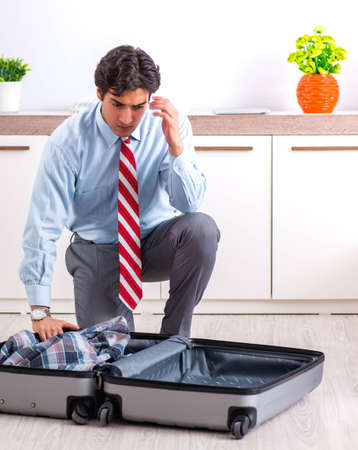 Young handsome businessman preparing for tripの写真素材