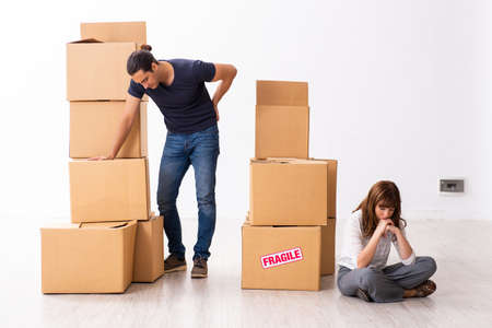 Young pair and many boxes in divorce settlement concept