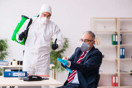 Old employee and young contractor in coronavirus concept