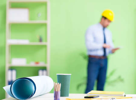 The young male architect working at the project