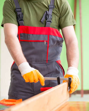 The young man carpenter working in workshopの写真素材