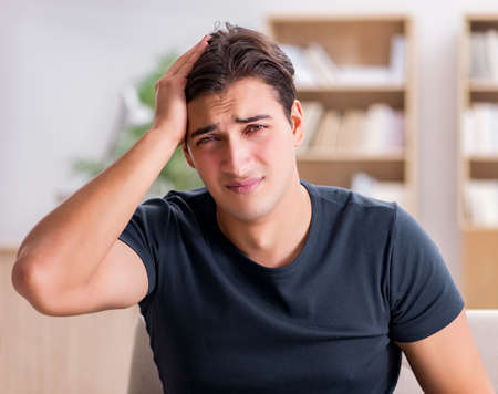 Young handsome man suffering from pain