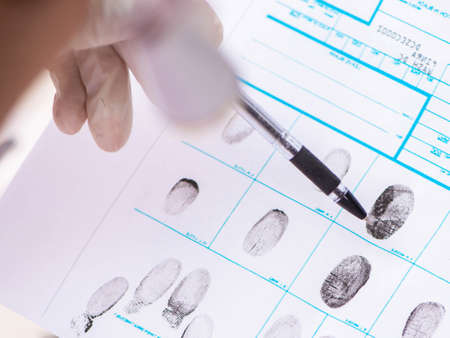 Forensic expert studying fingerprints in the labの写真素材