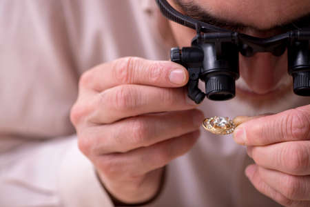 Old male jeweler at workshop
