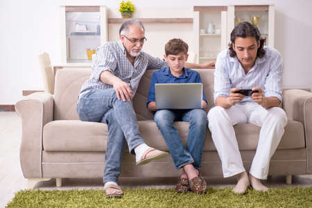 Boy and his father and his grandfother indoor