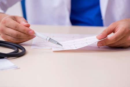 Young male doctor cardiologist working in the clinicの写真素材