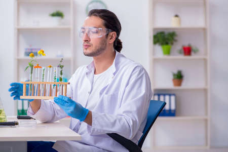 Young male chemist working in the lab