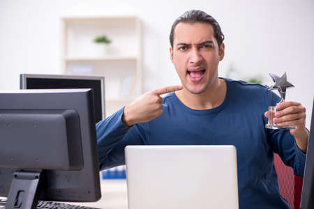 Young male it specialist working in the officeの写真素材