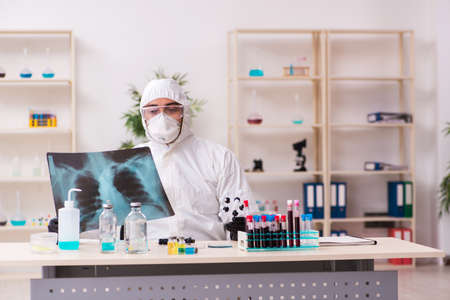 Doctor working in lab in coronavirus COVID-19 concept