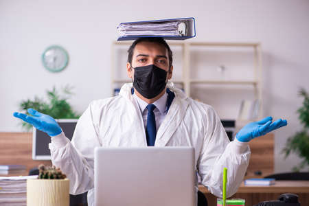 Young male employee in self-isolation conceptの写真素材