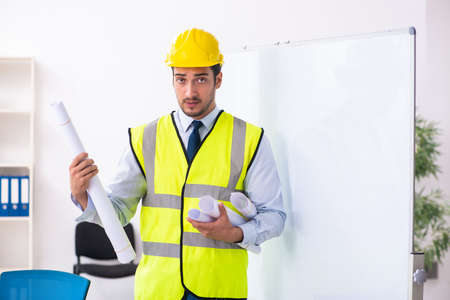 Young male architect in presentation concept