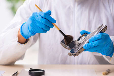 Male expert criminologist working in the lab for evidenceの写真素材