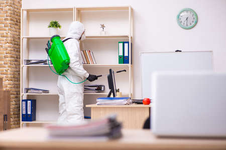 Contractor disinfecting office for COVID-19 coronavirusの写真素材