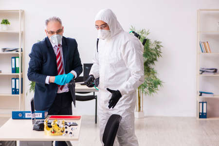 Old employee and young contractor in coronavirus conceptの写真素材