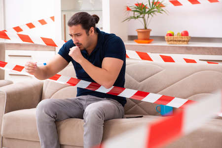 Young man feeling bored at home in self-isolation conceptの写真素材