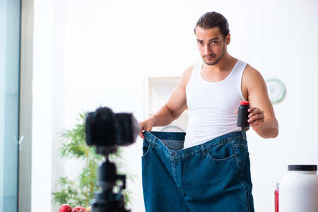 Young male blogger in dieting conceptの写真素材