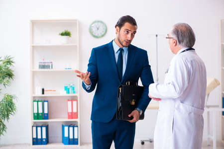 Male doctor and businessman discussing medical projectの写真素材
