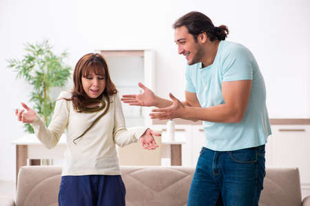 Young couple and snake in the flatの写真素材