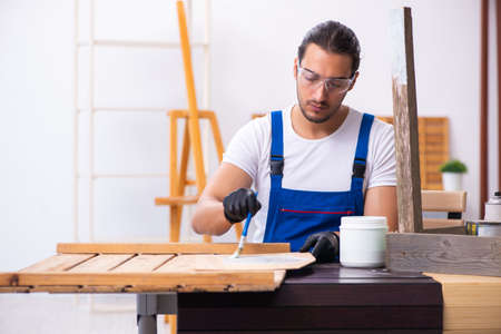 Young male contractor working in workshopの写真素材