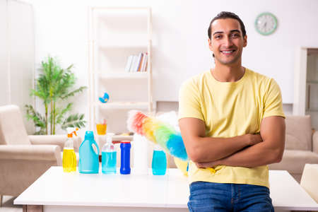Young male contractor doing housework at home