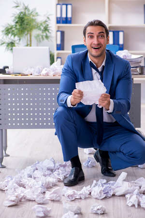 Businessman rejecting new ideas with lots of papersの写真素材