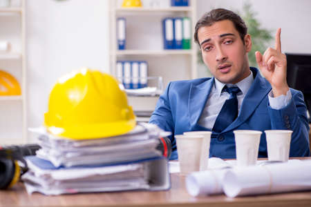 Young male architect working in the officeの写真素材