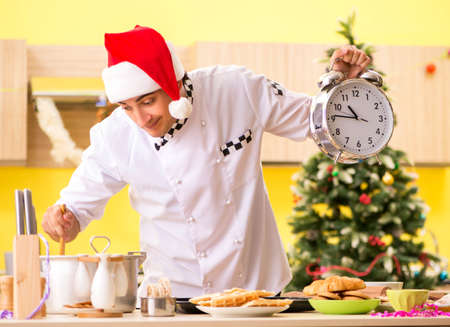 The young chef husband working in kitchen at christmas eveの写真素材