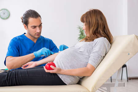 Young pregnant woman in blood transfusion conceptの写真素材