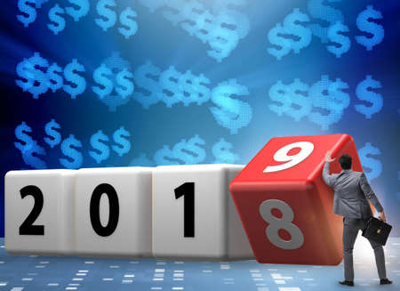 Businessman employee rotating cube to reveal number 2019