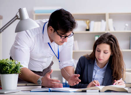Teacher explaining to student at lectureの写真素材