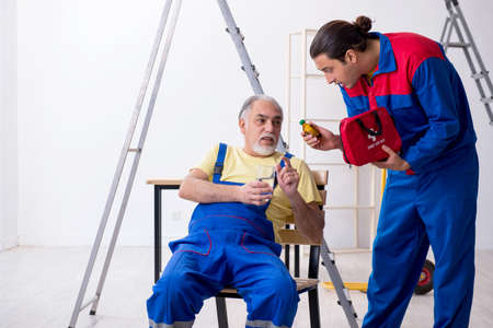 Two contractors in first aid conceptの写真素材