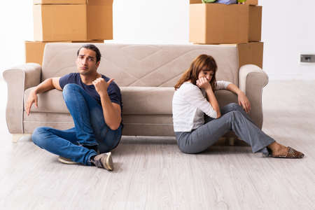Young pair and many boxes in divorce settlement conceptの写真素材
