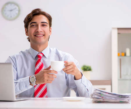 Young attractive businessman working in the officeの写真素材