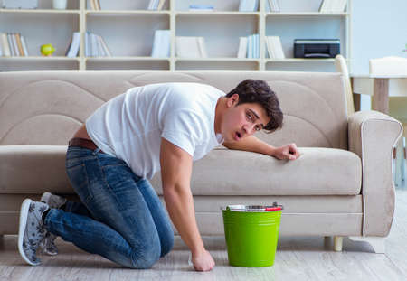 Sick man suffering at home from infection and bad stomachの写真素材