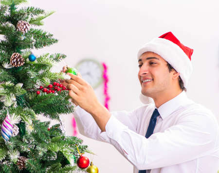 Employee businessman celebrating christmas in officeの写真素材