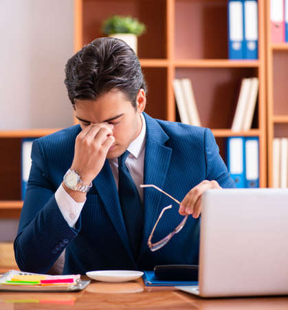 The young handsome businessman working in the officeの写真素材