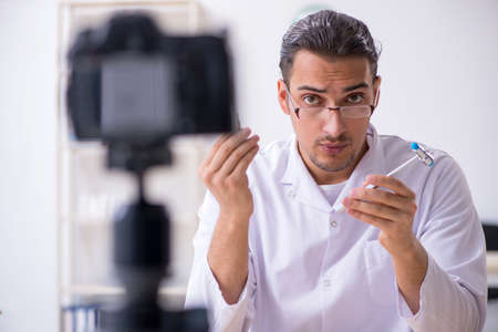 Young male doctor neurologist recording video for his blog