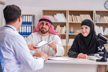 Doctor consulting arab family at hospitalの写真素材